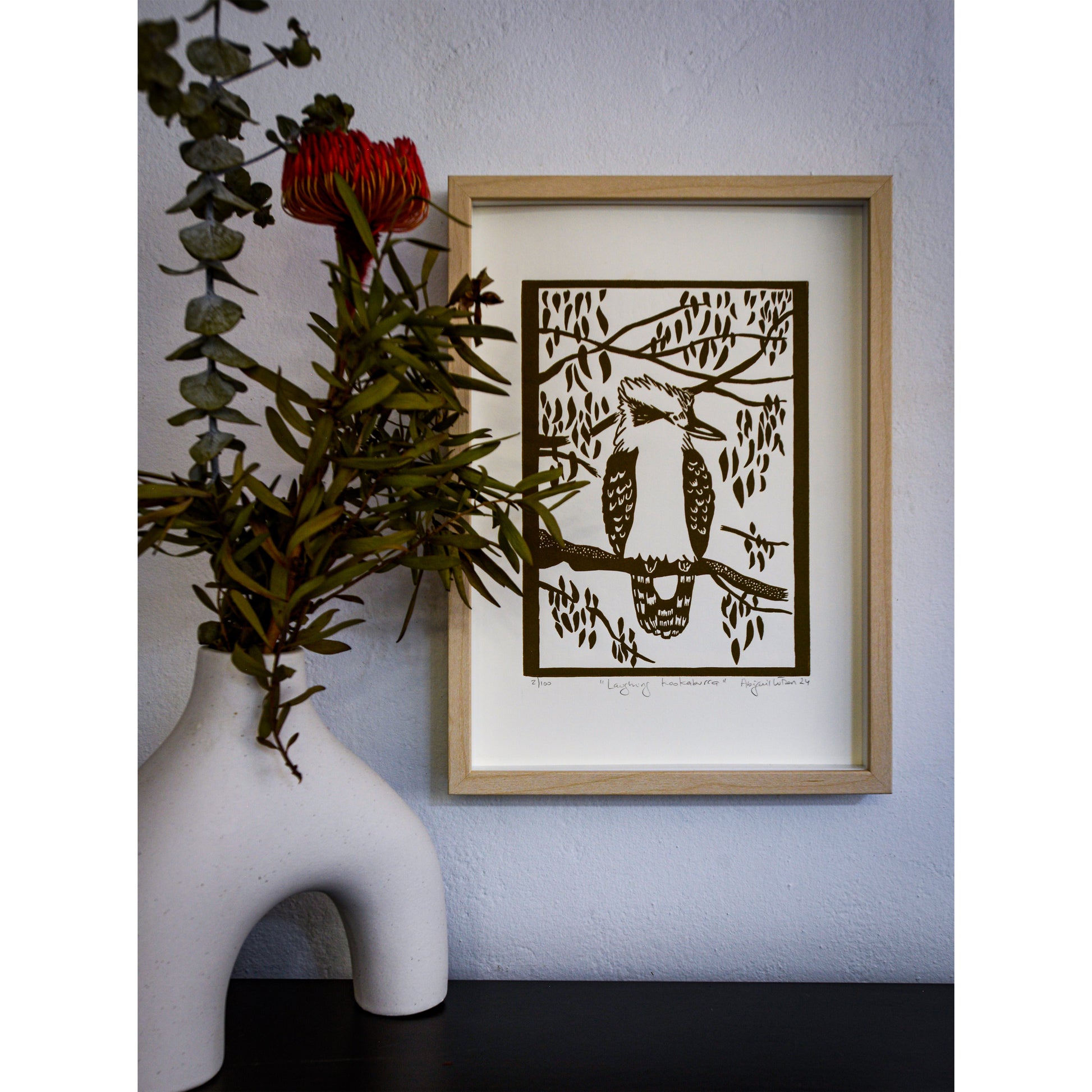 Handprinted linocut print of a laughing kookaburra, vibrant and detailed. Framed