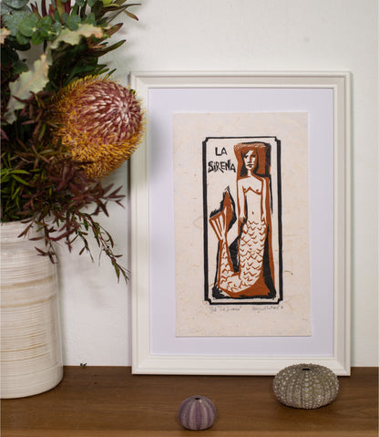 La Sirena linocut print framed on a wall