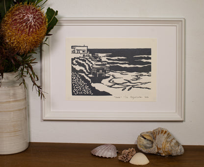 Tamarama linocut print, framed and displayed on a shelf